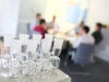 Referenzbild | CRM-Lösung für C. Gerhardt Analytical Systems: Im Vordergund - Laborgefäße, im Hintergrund - ein Team-Meeting